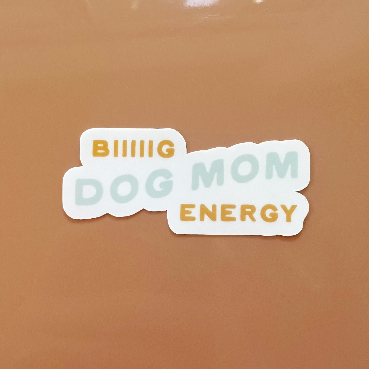 Orange background featuring sticker with the quote "Biiiig Dog Mom Energy"