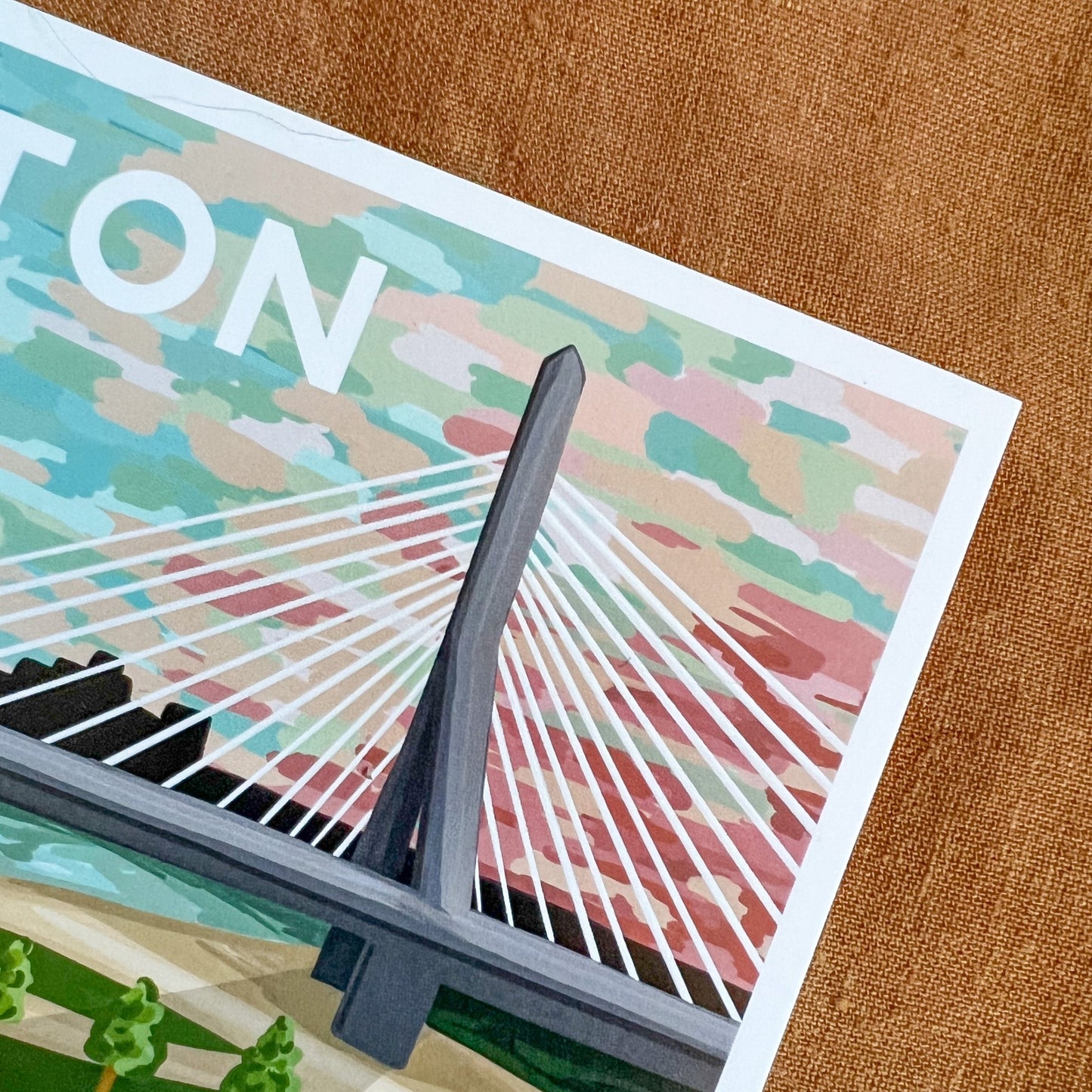 Close up of Boston postcard featuring the Zakim bridge at sunset