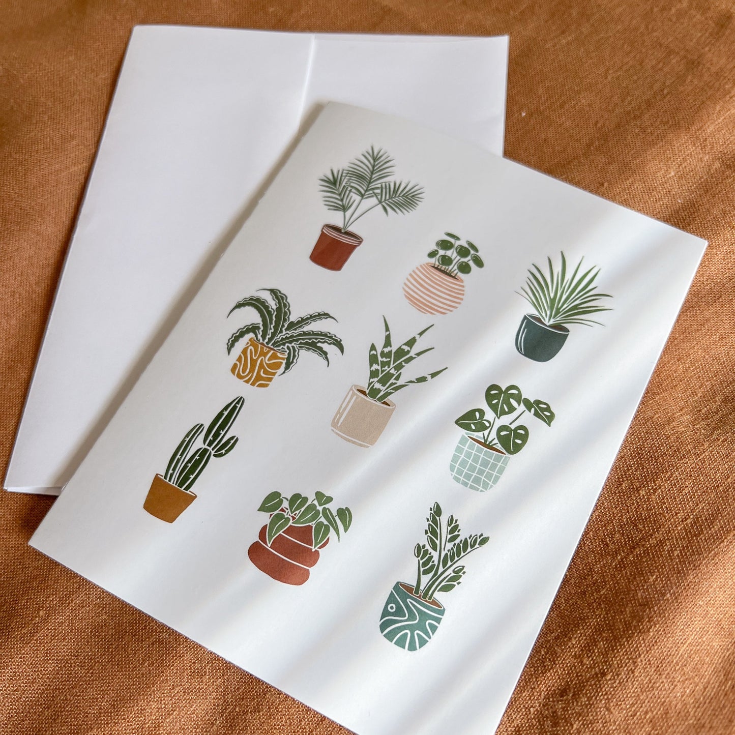 Plant greeting card in a rust fabric background
