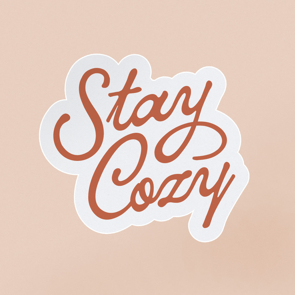 Sticker with quite "stay cozy" in red script lettering