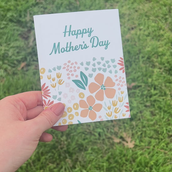 Front and Back of floral mother's Day Card held over grass