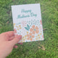 Front and Back of floral mother's Day Card held over grass