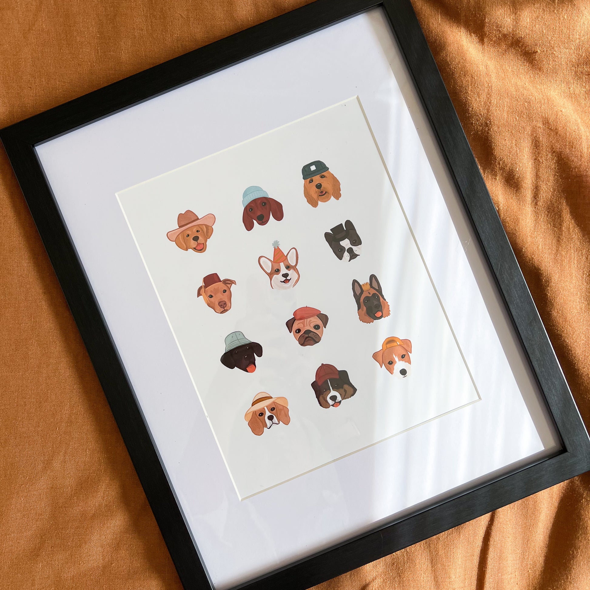 Dogs in Hats Art Print in black frame.