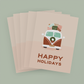 Stack of pink cards depicting a vintage-style van with presents on top and the message "Happy Holidays"