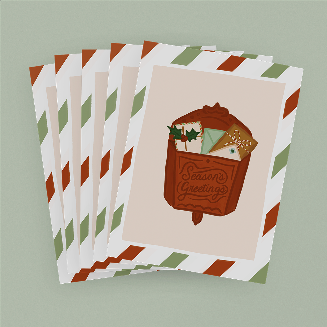 Stack of Holiday Cards featuring a red vintage mailbox with the words "Season's Greetings"