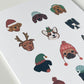Close up of white card with 12 dogs, each in a different holiday hat