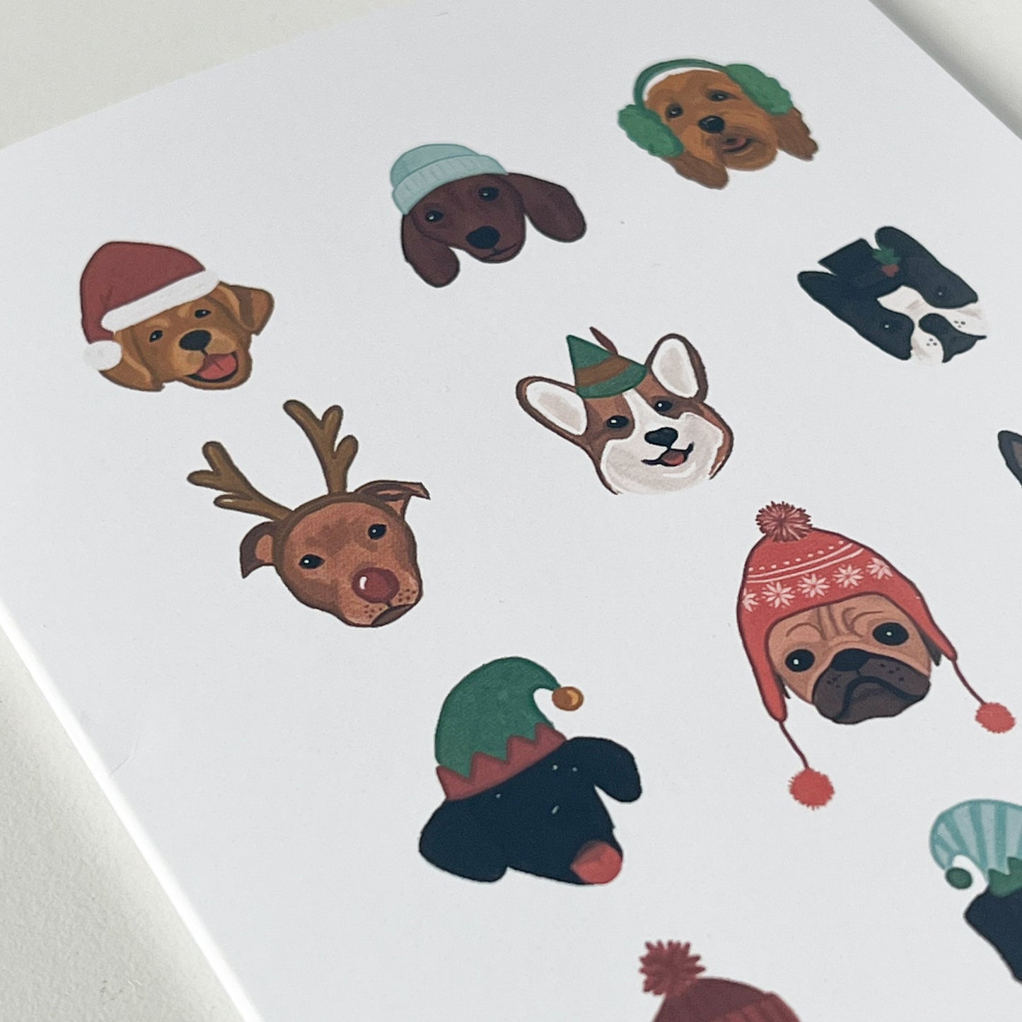 Close-up of holiday card featuring dogs in winter hats