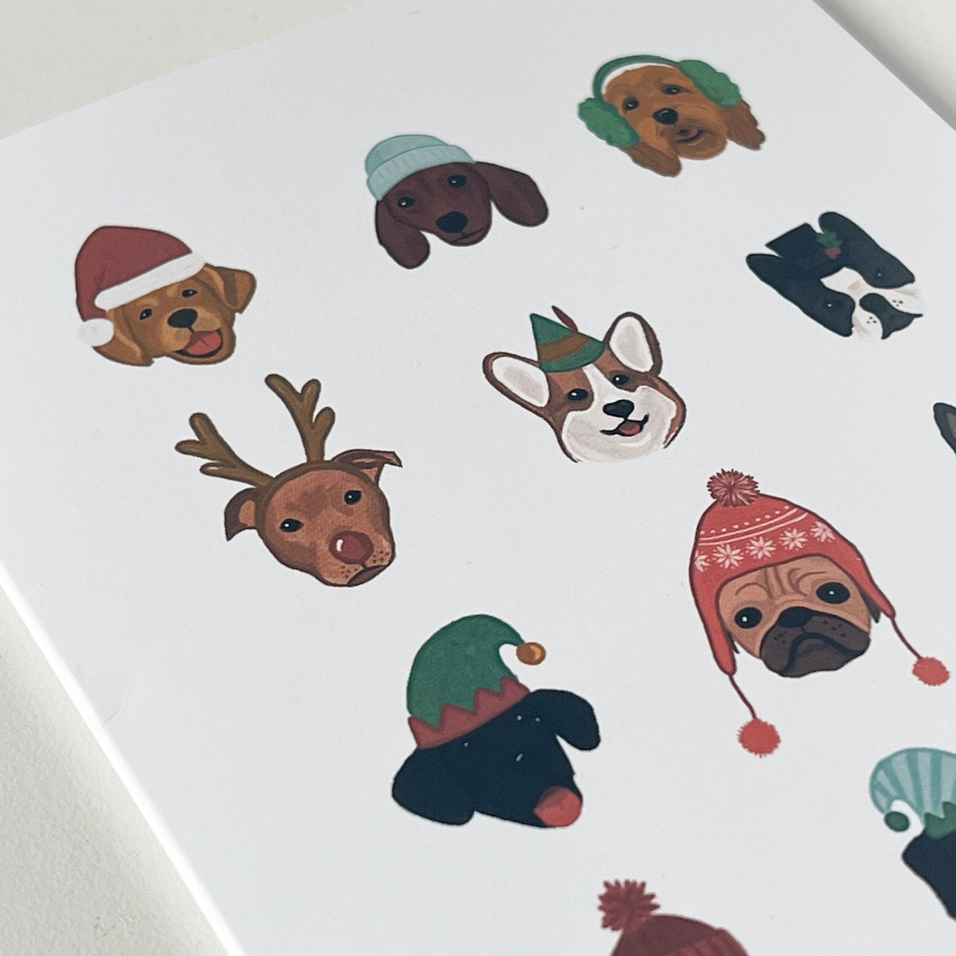 Close-up of holiday card featuring dogs in winter hats
