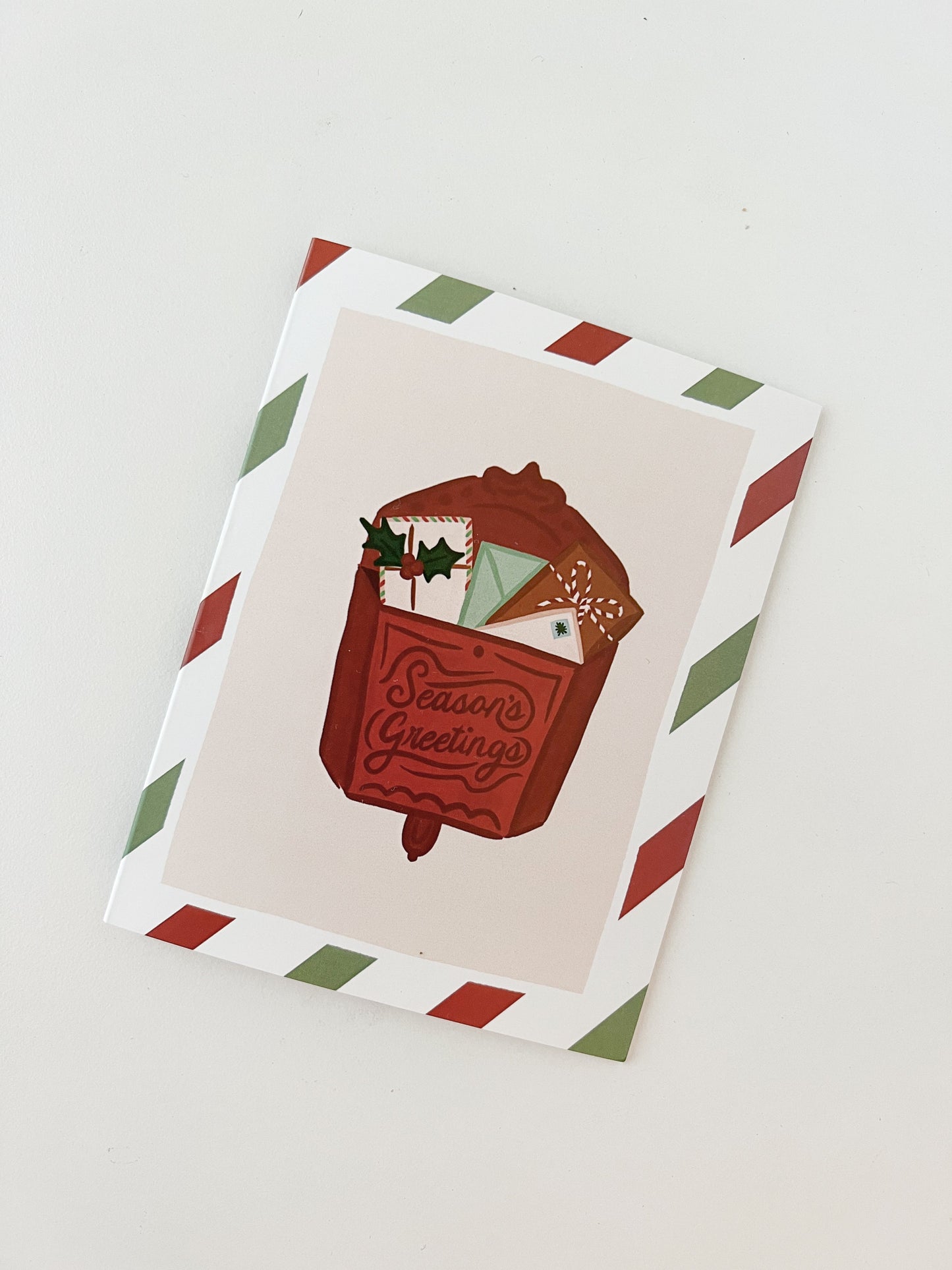 Holiday Card featuring a red vintage mailbox with the words "Season's Greetings" on white background