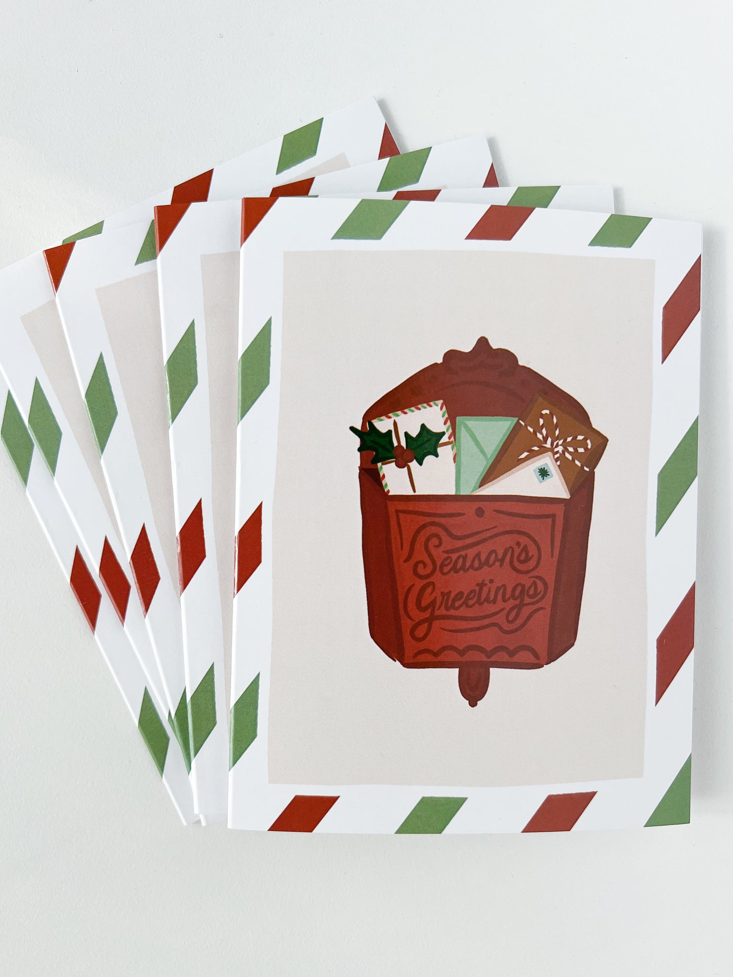 Stack of Holiday Cards featuring a red vintage mailbox with the words "Season's Greetings"