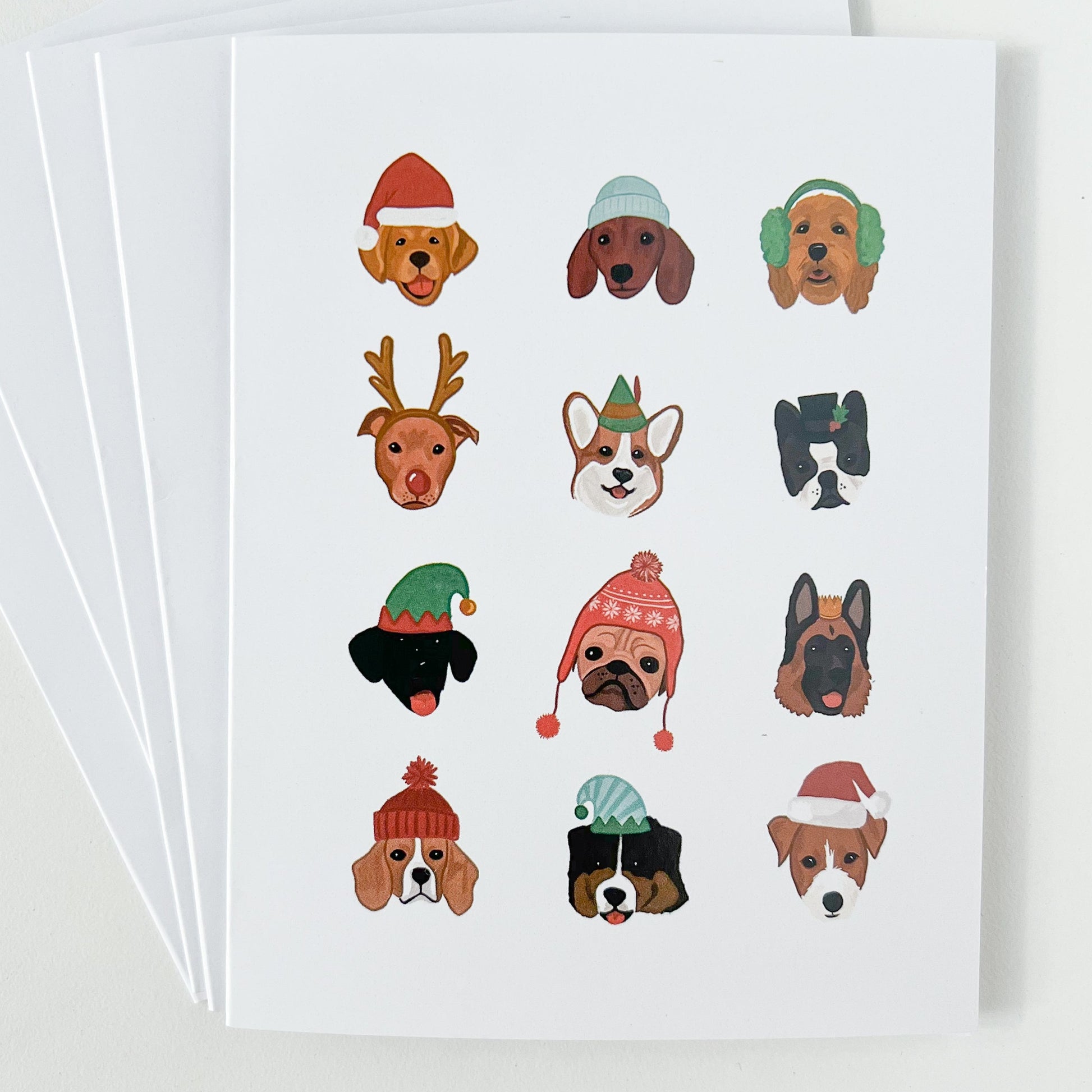 Stack of holiday cards featuring dogs in winter hats