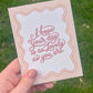 Pink Lovely Day greeting card being held over grass