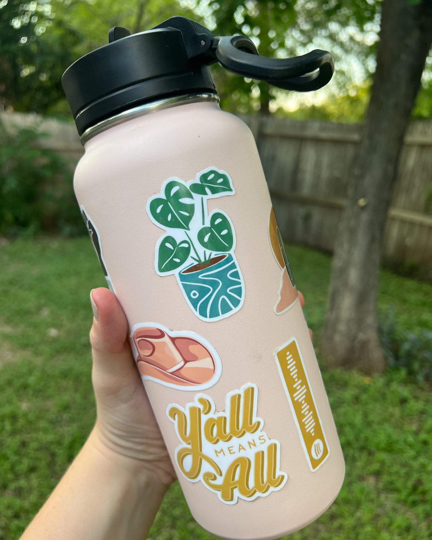 Water bottle showcasing Monstera Plant Sticker amongst other Just Right Design Co. stickers. 