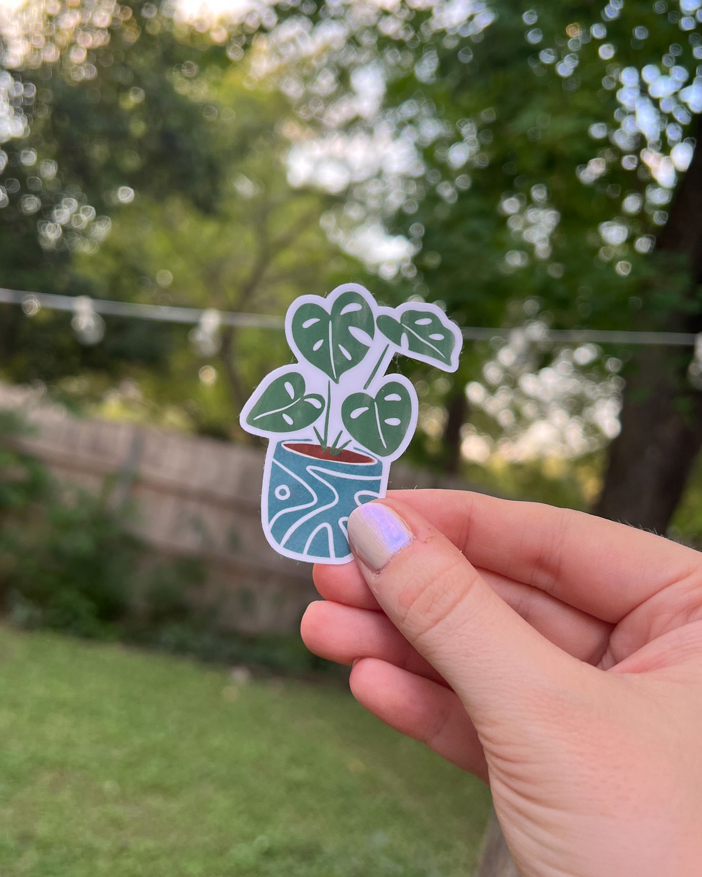 Monstera Plant Sticker with 4 leaves in a quirky blue pot.