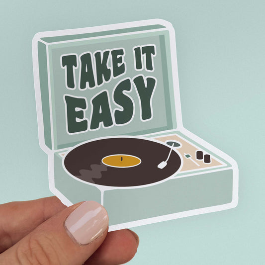Sticker of a teal record playing with vinyl record and the quote "Take it easy" in wavy lettering.
