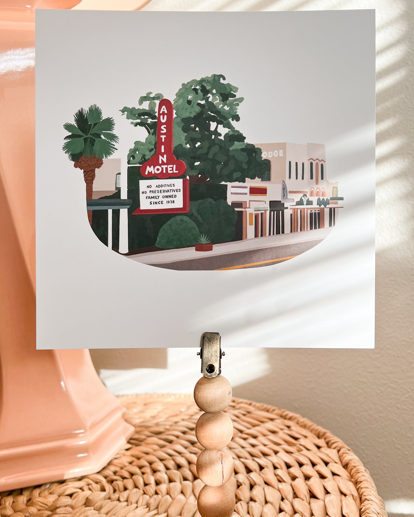 South Congress Art Print shown clipped to a quirky photo stand with sunlight catching the print.